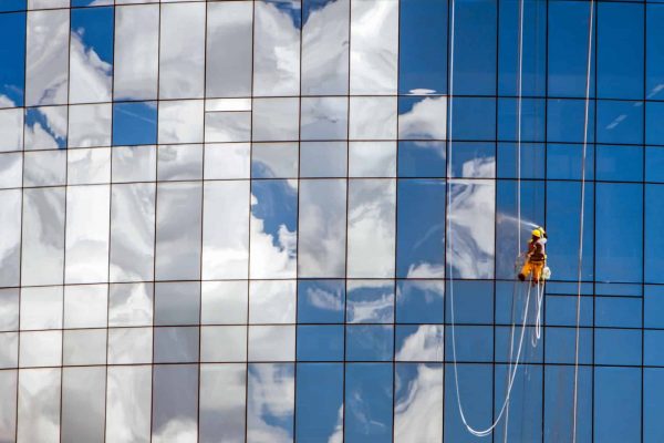 worker-cleaning-glass-windows-of-modern-building-2023-11-27-05-01-02-utc (1)